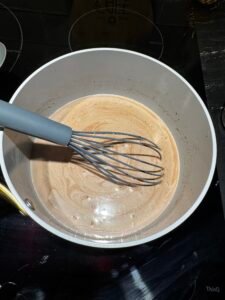 Classic hot chocolate simmering in a saucepan