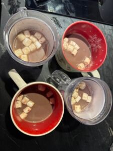 Hot chocolate with marshmallows in decorative holiday mugs